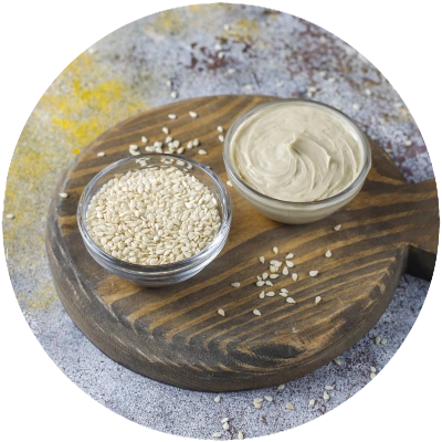 sesame seeds and tahini on wooden board
